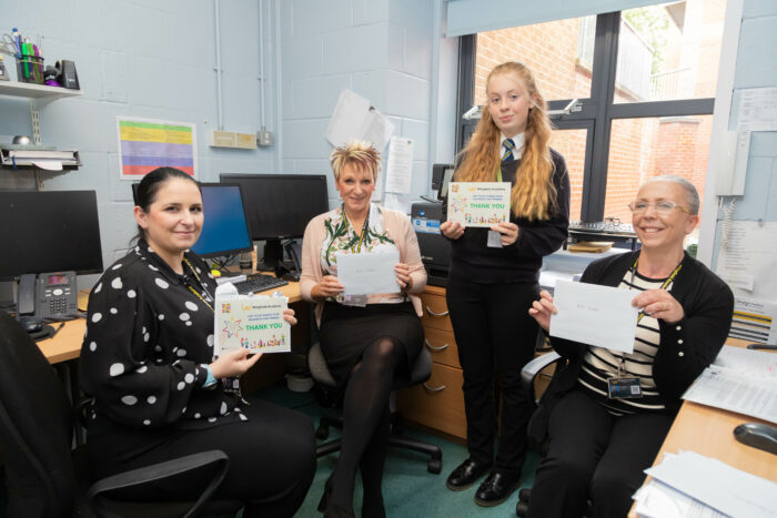 Staff members receiving a thank you card